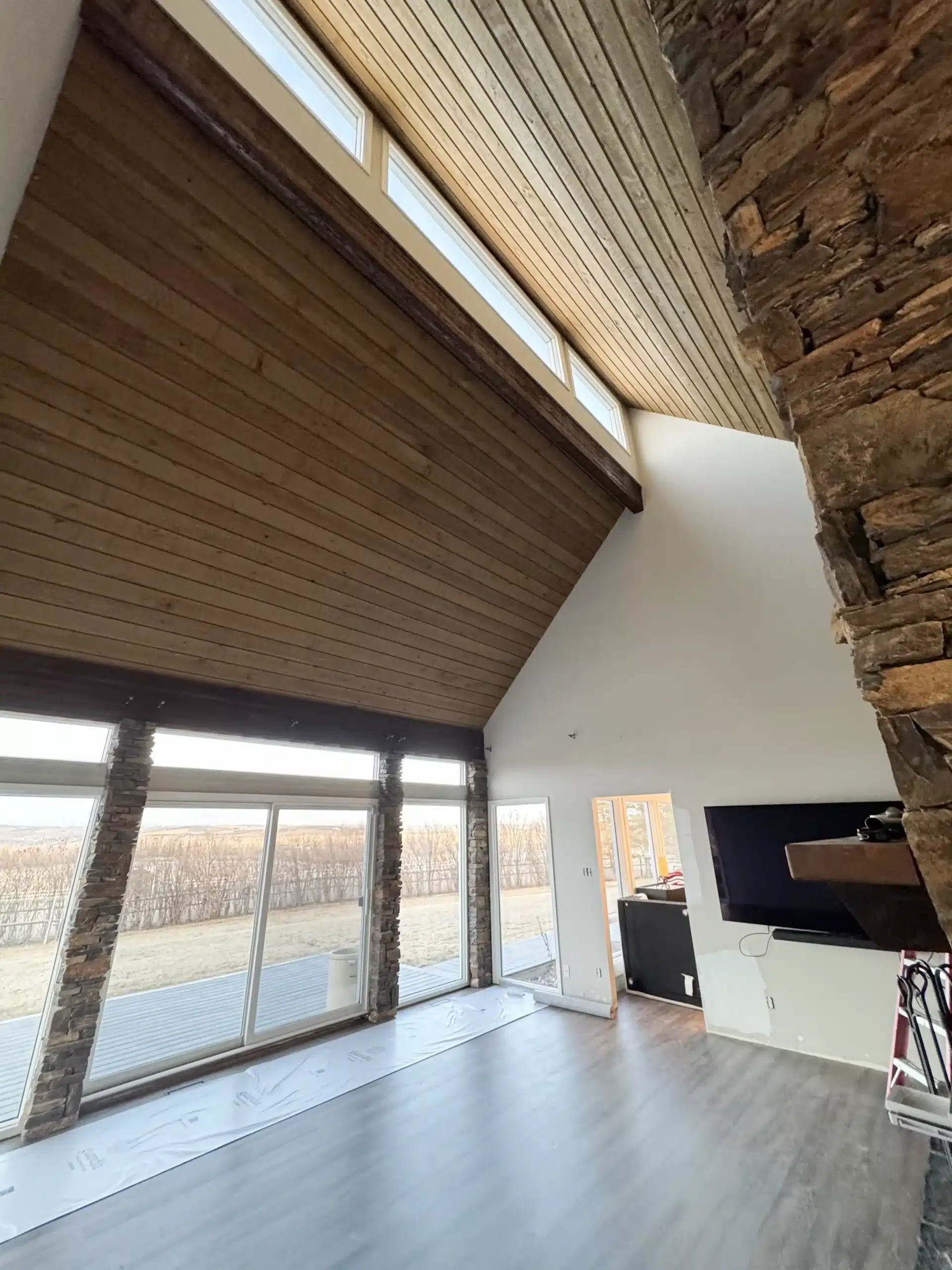 Professionally refinished wood ceiling and trim in a Calgary home.